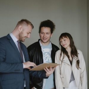 Happy couple meeting with a real estate agent discussing paperwork indoors.